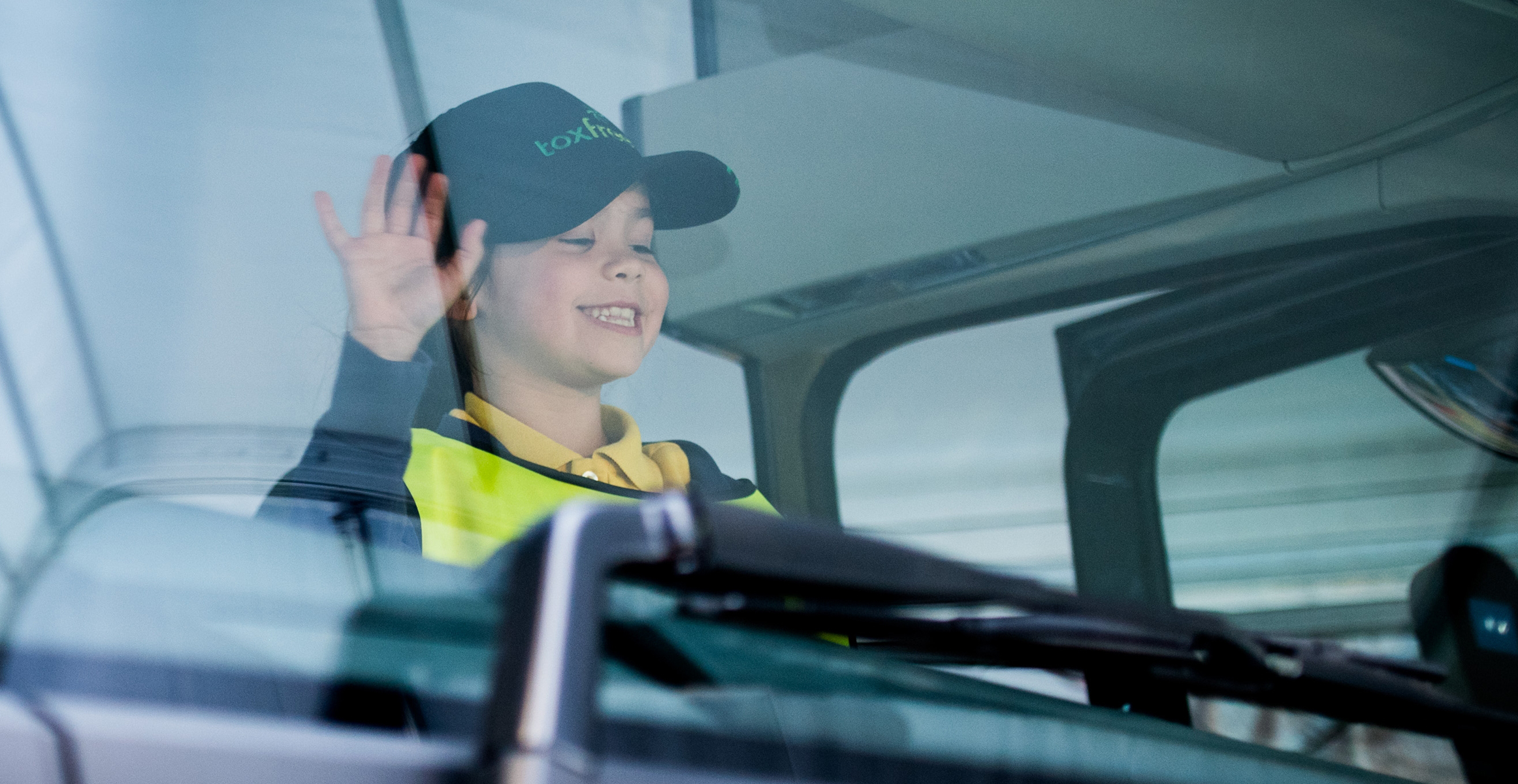 Volvo Trucks stop look wave smiling girl banner